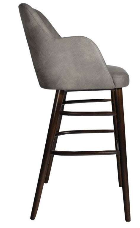 Side view of the Aztec Bar Stool - Steel Grey featuring a cushioned seat and backrest upholstered in steel grey fabric with a sturdy dark wood frame and footrest bars.