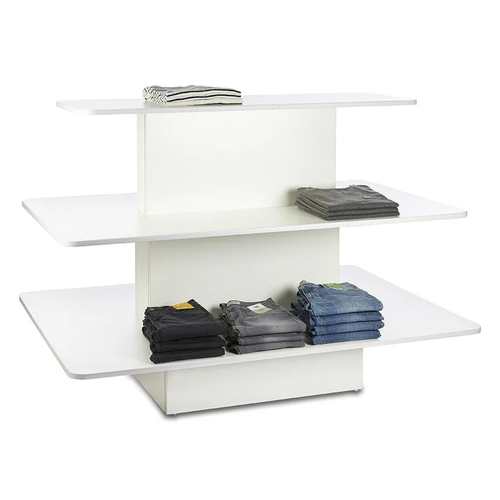 White freestanding island display gondola used for product merchandising in a retail interior