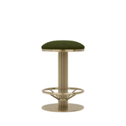 Rafferty Bar Swivel Stool upholstered in olive green velvet with a brass-finished stainless steel frame, featuring decorative vertical ridges, a circular footrest, and 360-degree swivel functionality, ideal for hospitality, hotel, restaurant, and bar interiors. Bar stool with green cushioned seat and gold metal frame on a beige background