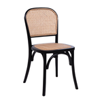 Black framed stacking side chair featuring a natural rattan seat pad and matching woven rattan backrest, showcasing the Ronda Stacking Side Chair Seat Pad - Natural Rattan.