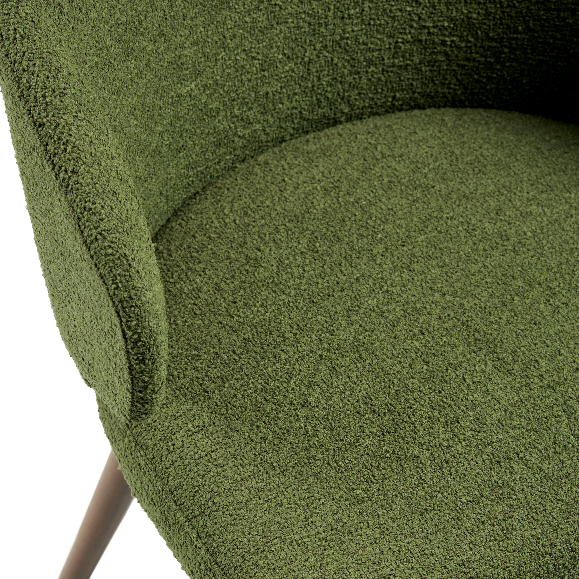 Close-up view of the textured upholstery and curved armrest of the Selma Armchair - Forest Green, highlighting its elegant fabric and wooden leg detail.