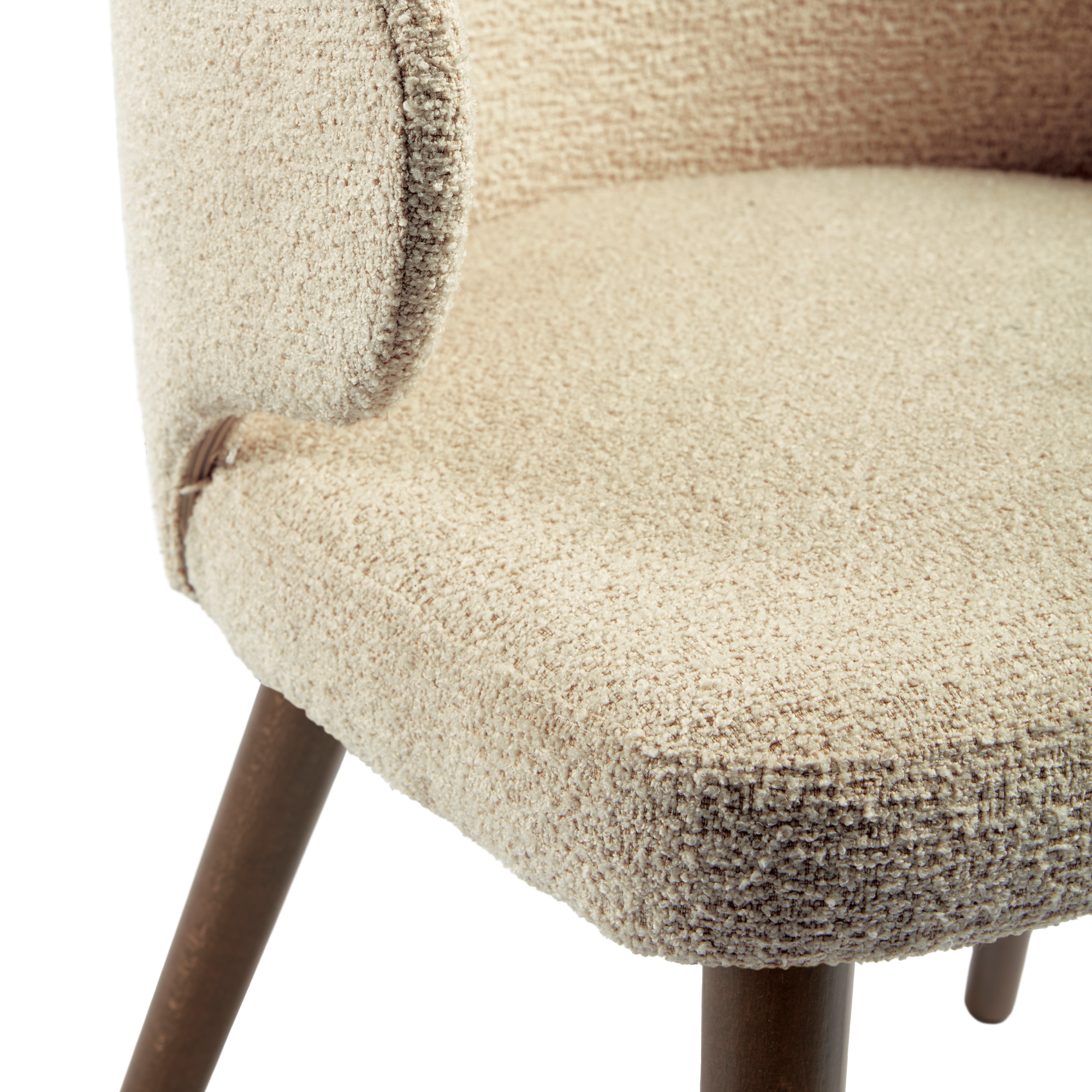 Close-up of the textured fabric upholstery and wooden legs of the Selma Armchair - Natural, highlighting its soft, natural tones and craftsmanship.
