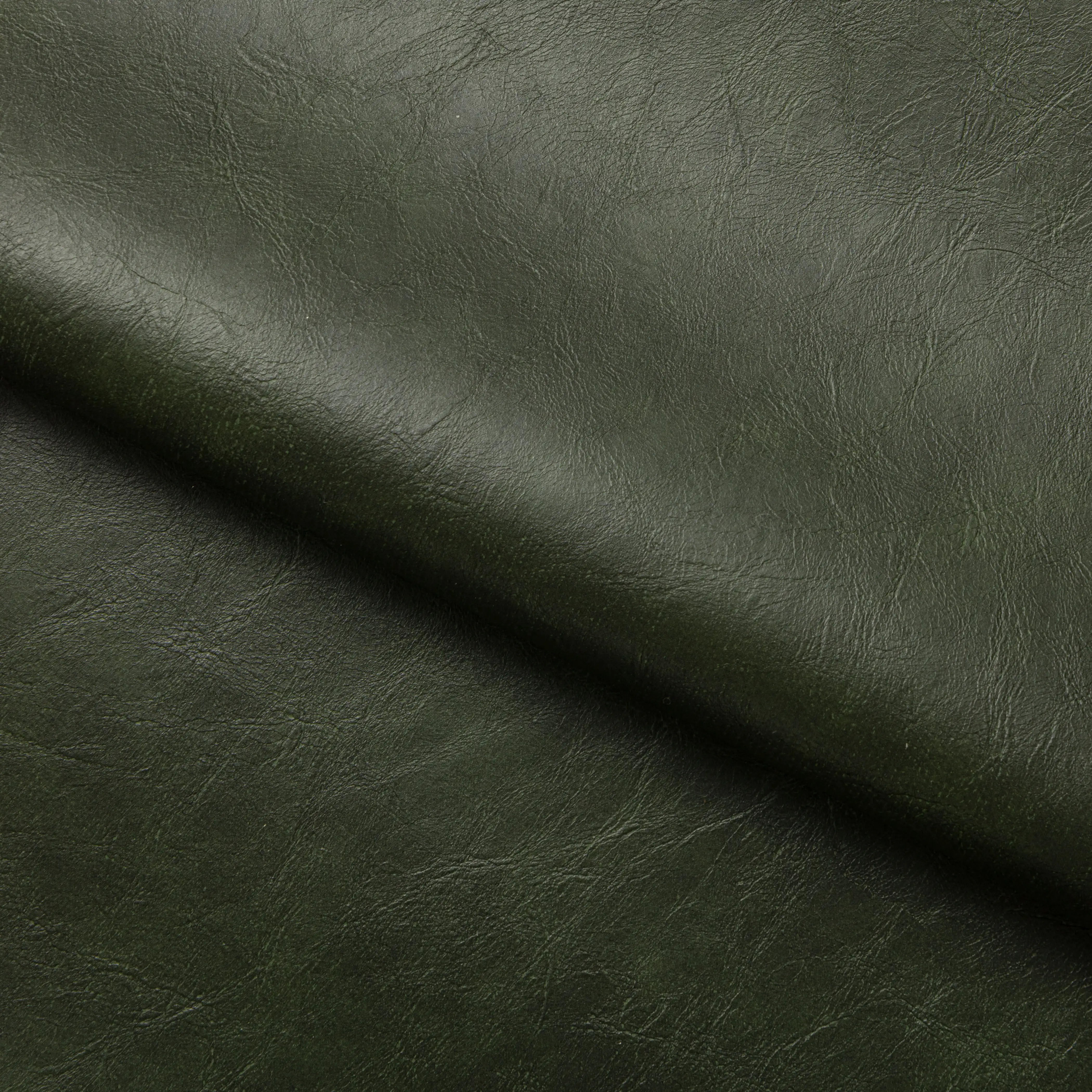 Rafferty Bar Swivel Stool upholstered in vintage tan faux leather with a brass-finished stainless steel frame, featuring decorative vertical ridges, a circular footrest, and swivel functionality, ideal for hospitality, restaurant, hotel, and bar interiors. Dark green leather texture with a diagonal line