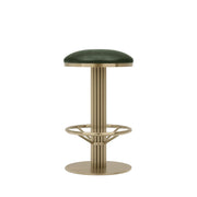 Rafferty Bar Swivel Stool upholstered in vintage tan faux leather with a brass-finished stainless steel frame, featuring decorative vertical ridges, a circular footrest, and swivel functionality, ideal for hospitality, restaurant, hotel, and bar interiors. Bar stool with green cushioned seat and brass base on a beige background