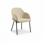 Westbury Armchair - Natural featuring a curved upholstered seat and backrest in soft natural fabric with slender black metal legs, designed for modern commercial interiors.