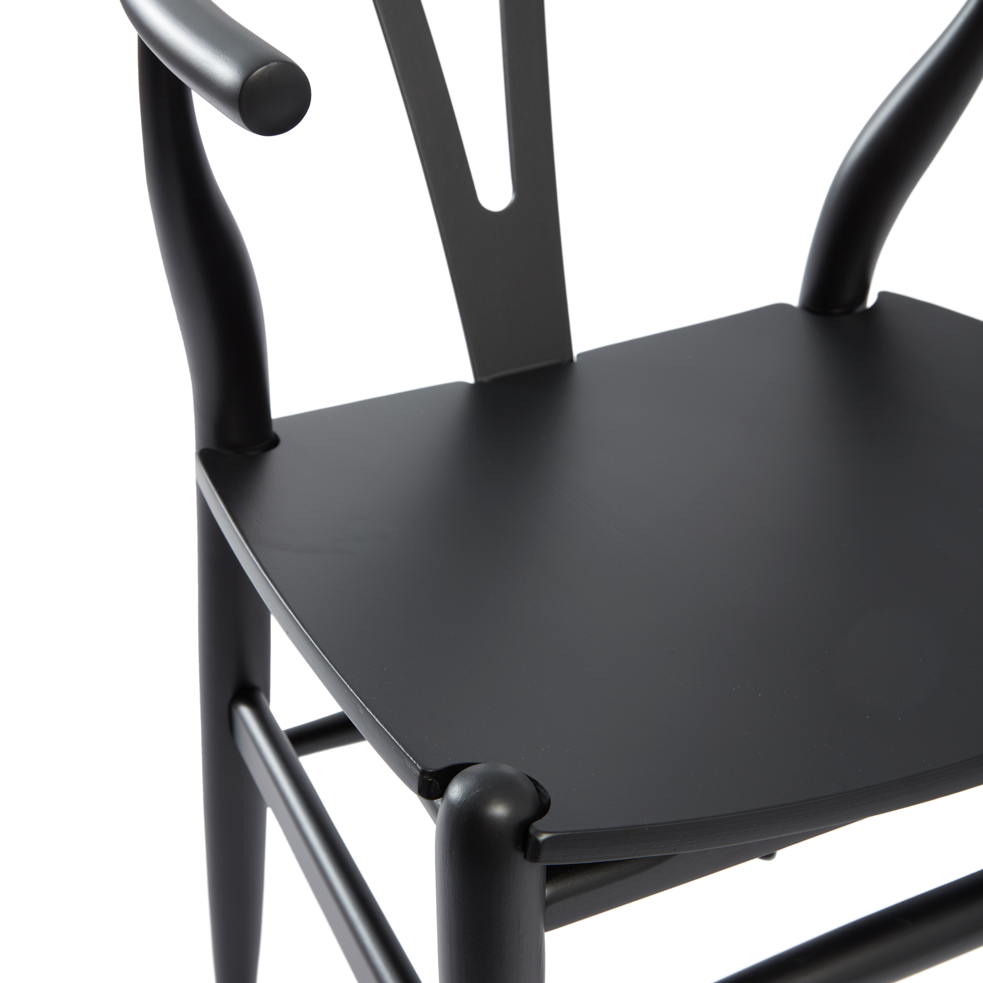 Close-up view of the seat and curved arms of the Wishbone Style Armchair - Solid Beech - Satin Black, showcasing its smooth finish and elegant design.
