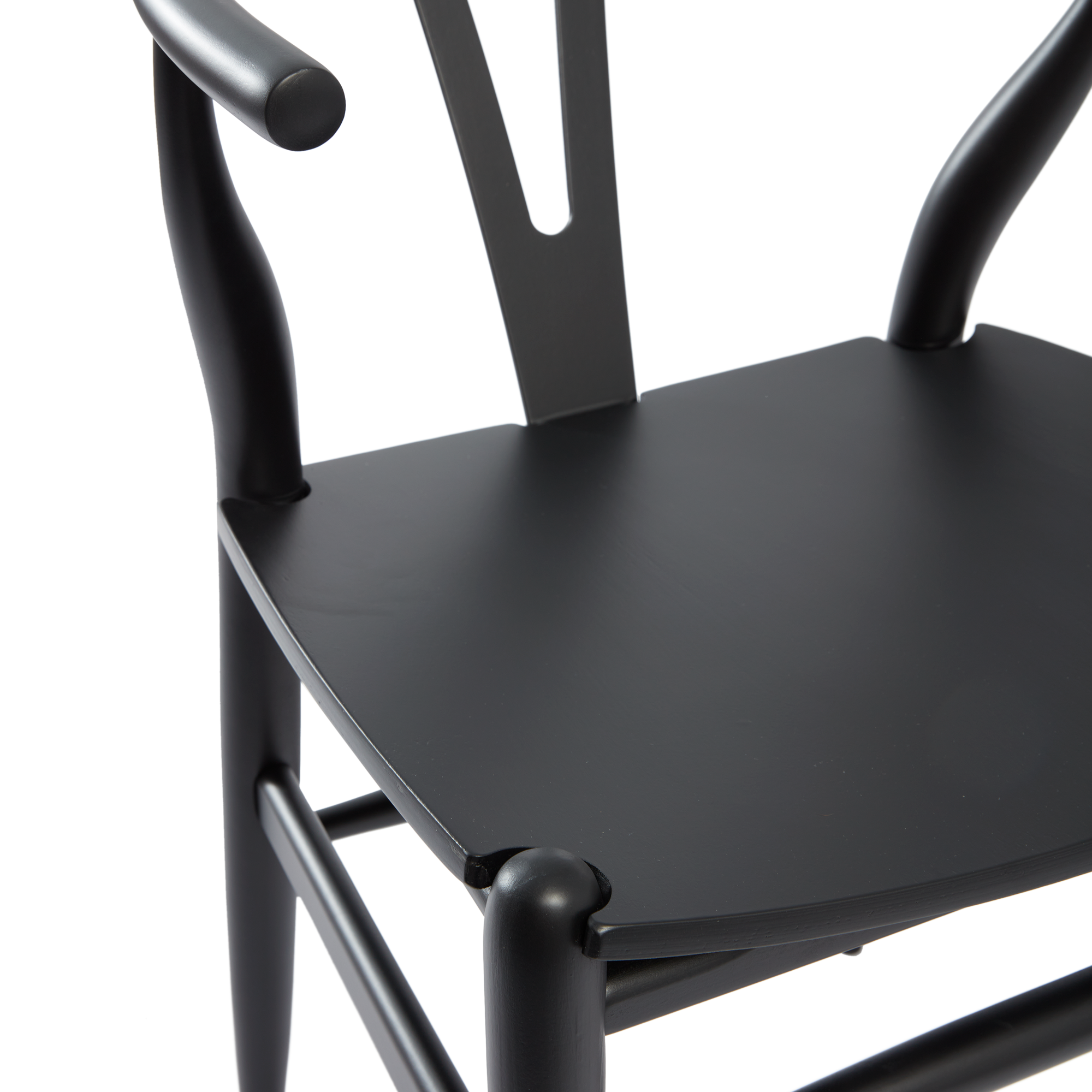 Close-up view of the seat and curved arms of the Wishbone Style Armchair - Solid Beech - Satin Black, showcasing its smooth finish and elegant design.
